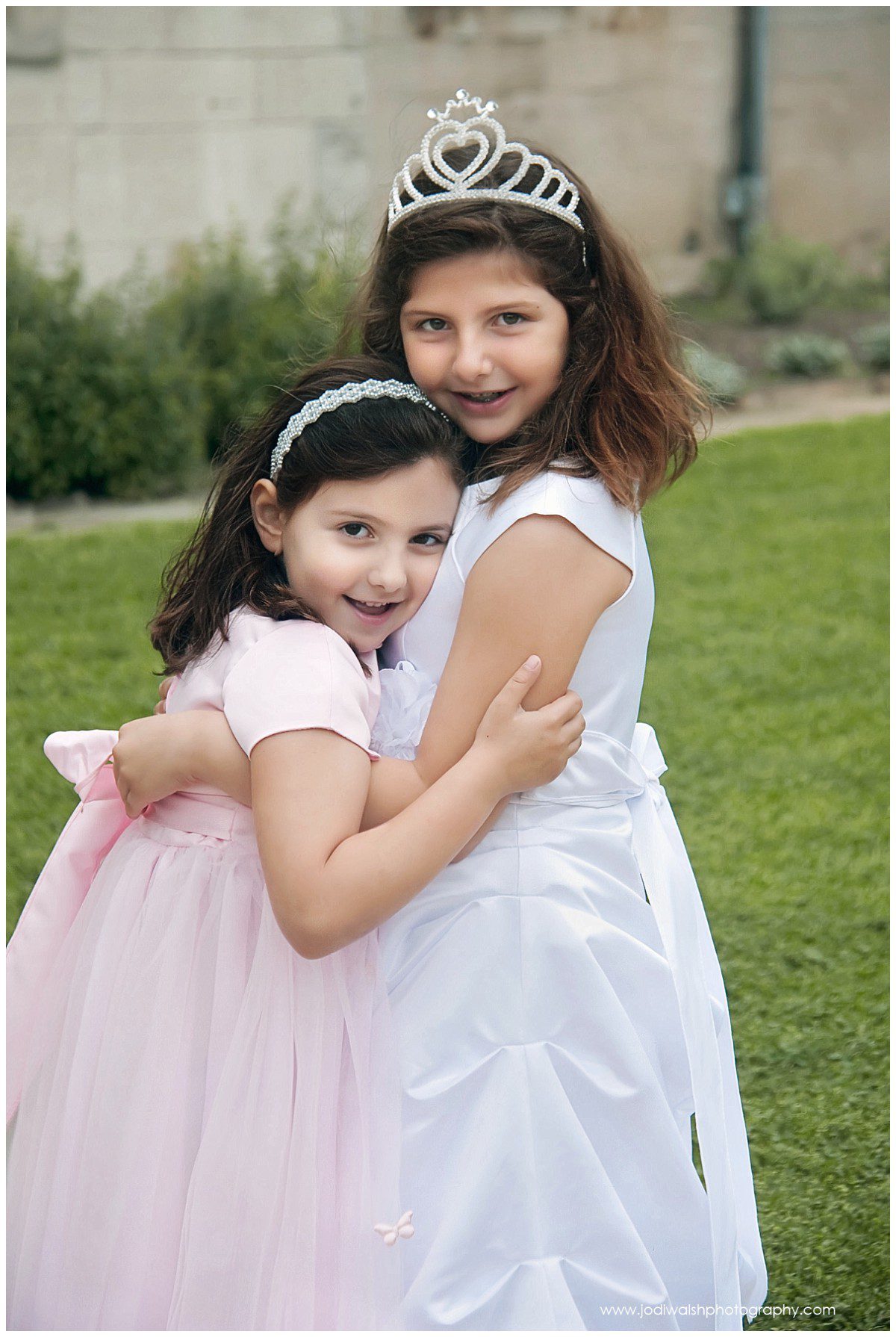 sisters hugging during First Holy Communion portraits at Hartwood Acres