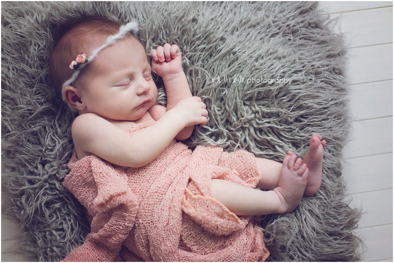 newborn girl in peach wrap sleeping on gray fur, Erie