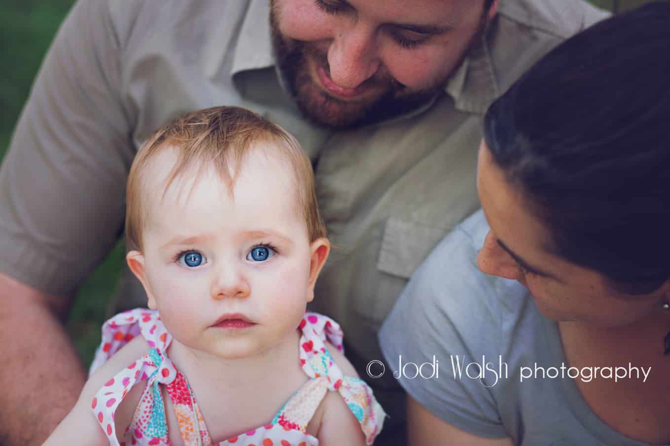 blue eyed baby girl with mom and dad