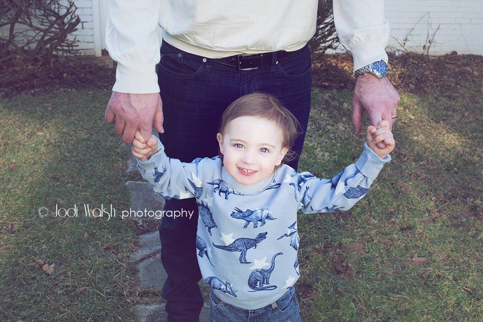 toddler with dad's hands