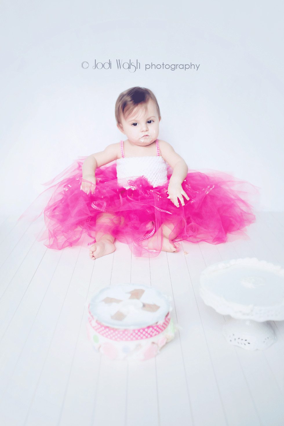 1 yr old with cake knocked over, smash cake session, first birthday, Erie baby photography