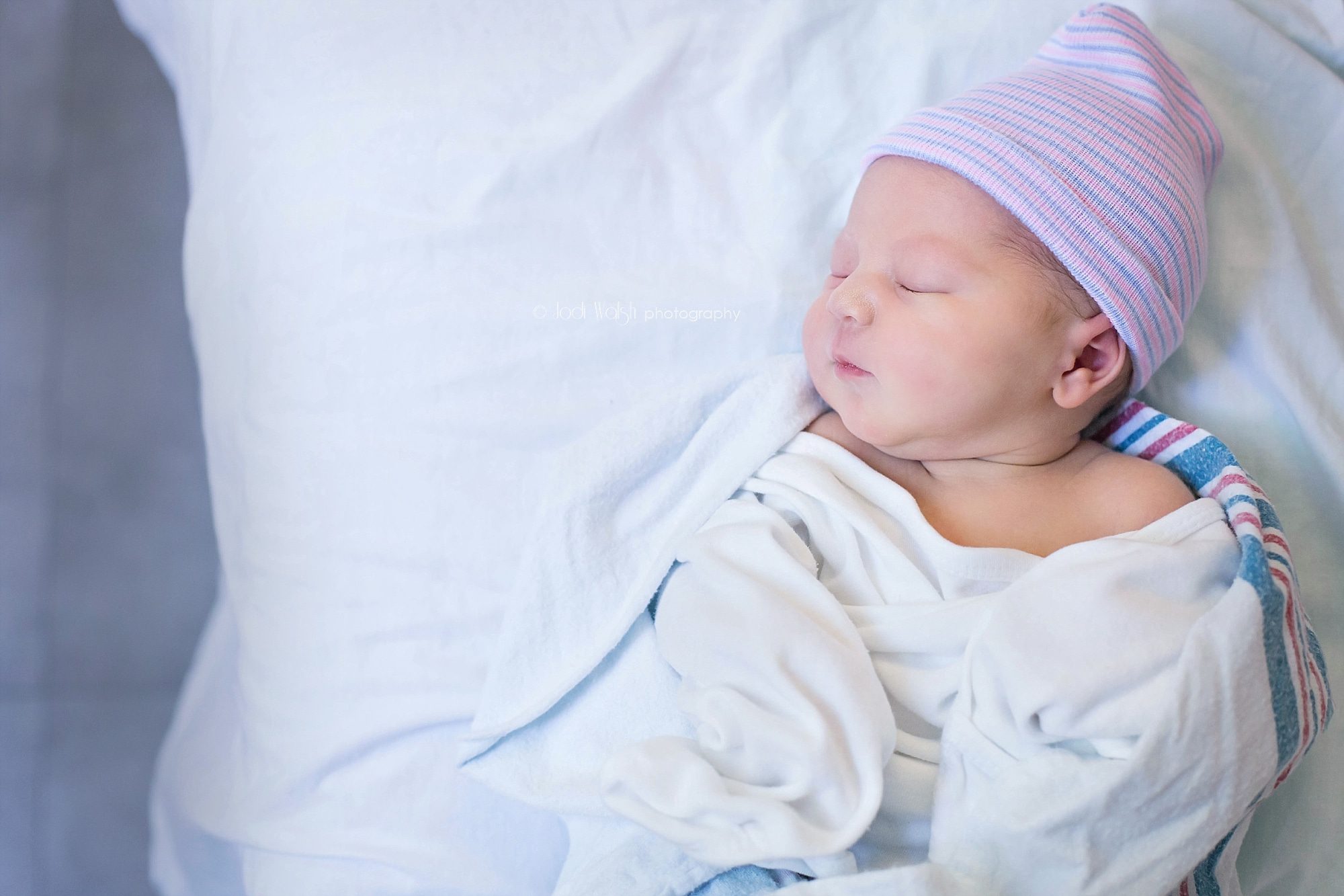 newborn baby girl sleeping on hospital bed
