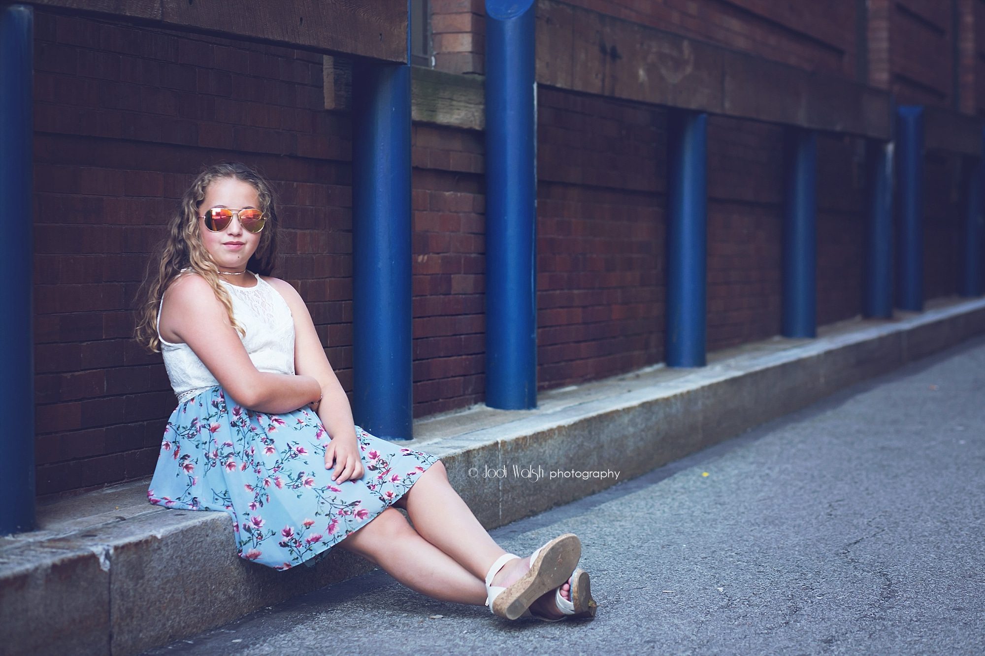 tween girl with sunglasses sitting in alley, downtown Pittsburgh