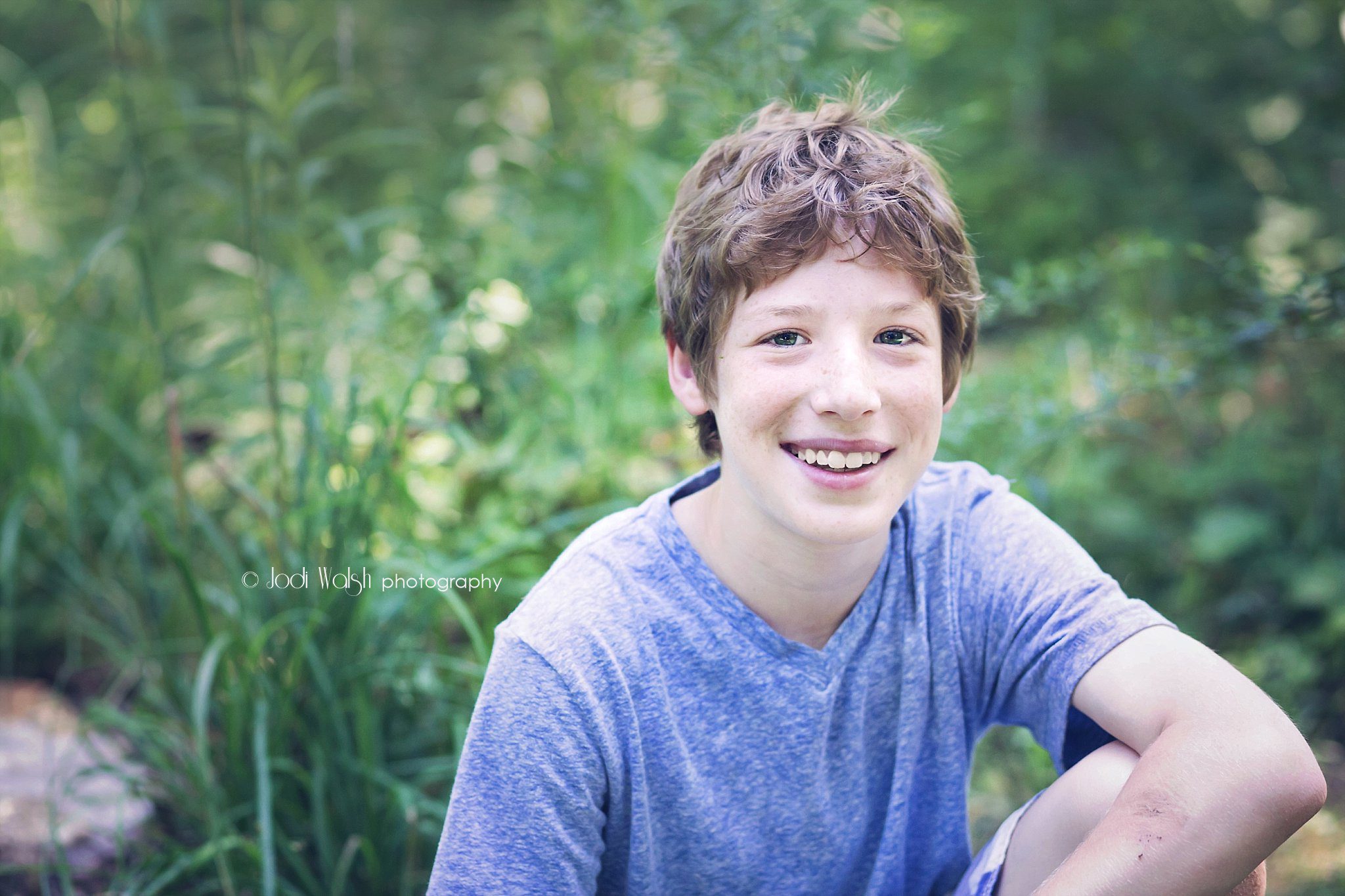 portrait session with tween boy with blue shirt in the woods outside of Pittsburgh