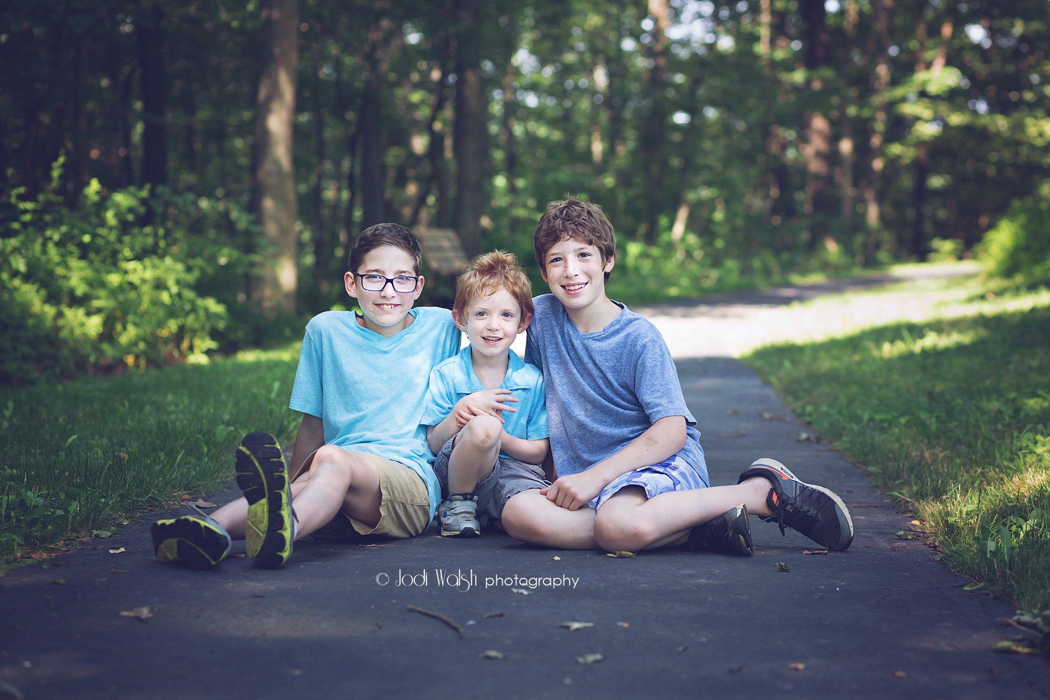 three brothers portrait session sitting in Pittsburgh park