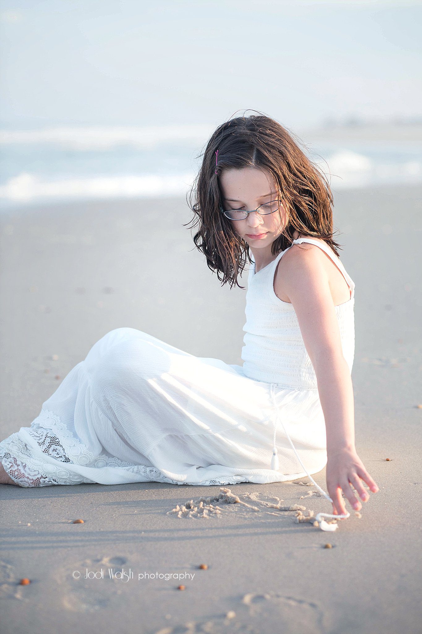 girl in white dress sitting on the beach, Long Beach Island New Jersey