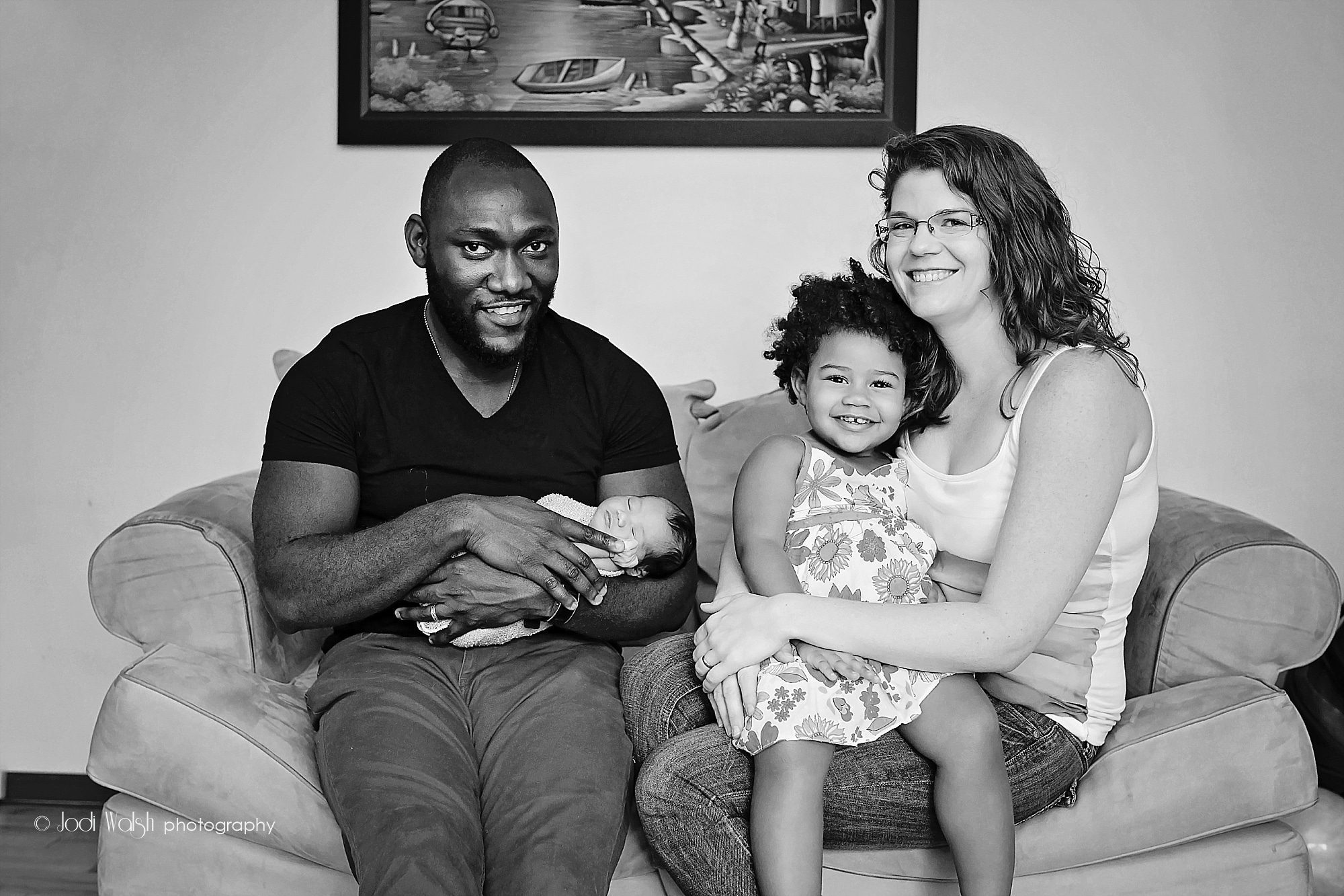 documentary style portrait of mother, father, toddler big sister and newborn