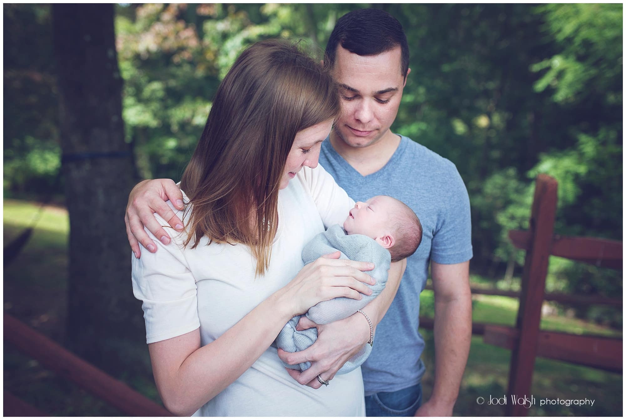 backyard family portrait with newborn