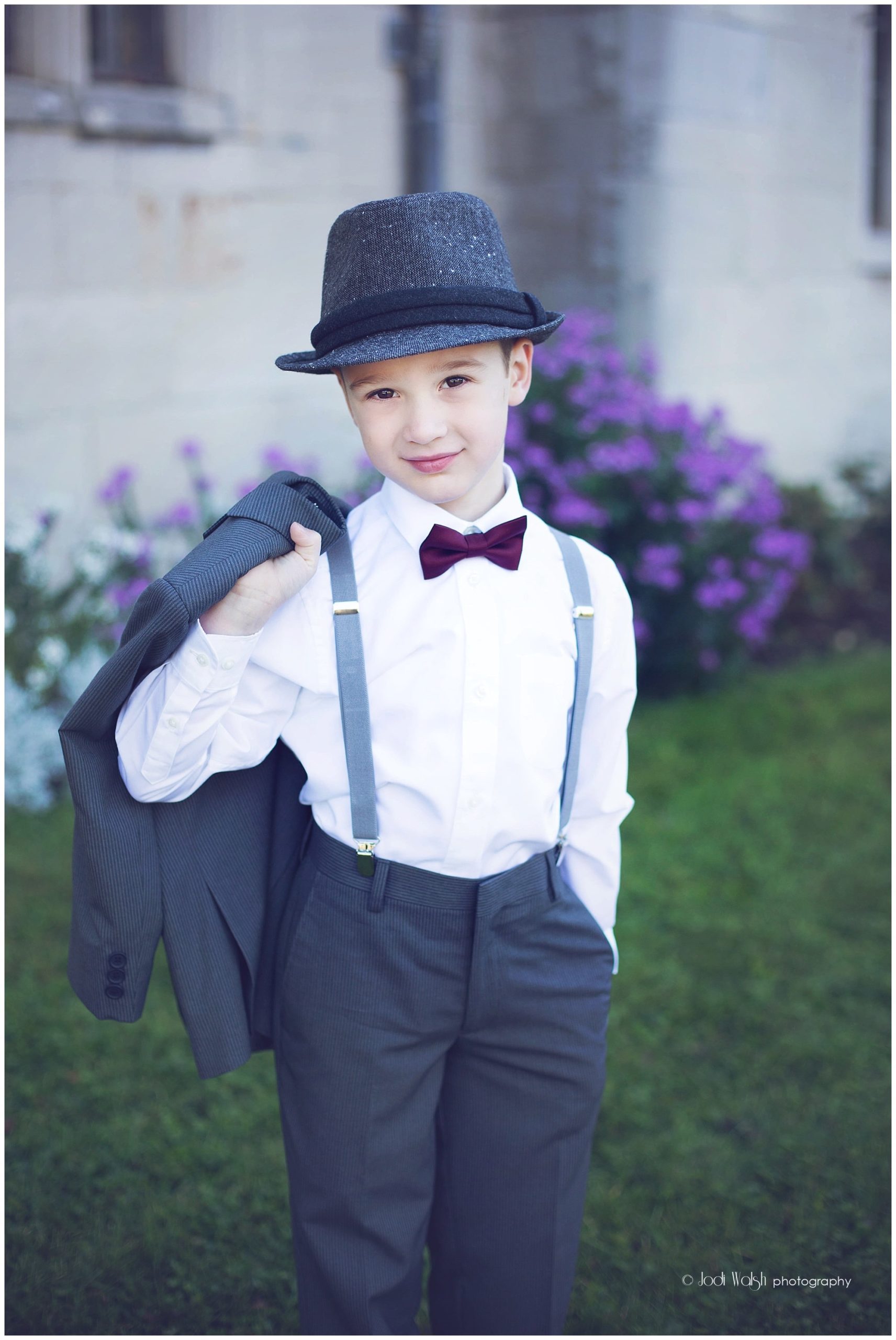 little boy in hat, suspenders and bow tie