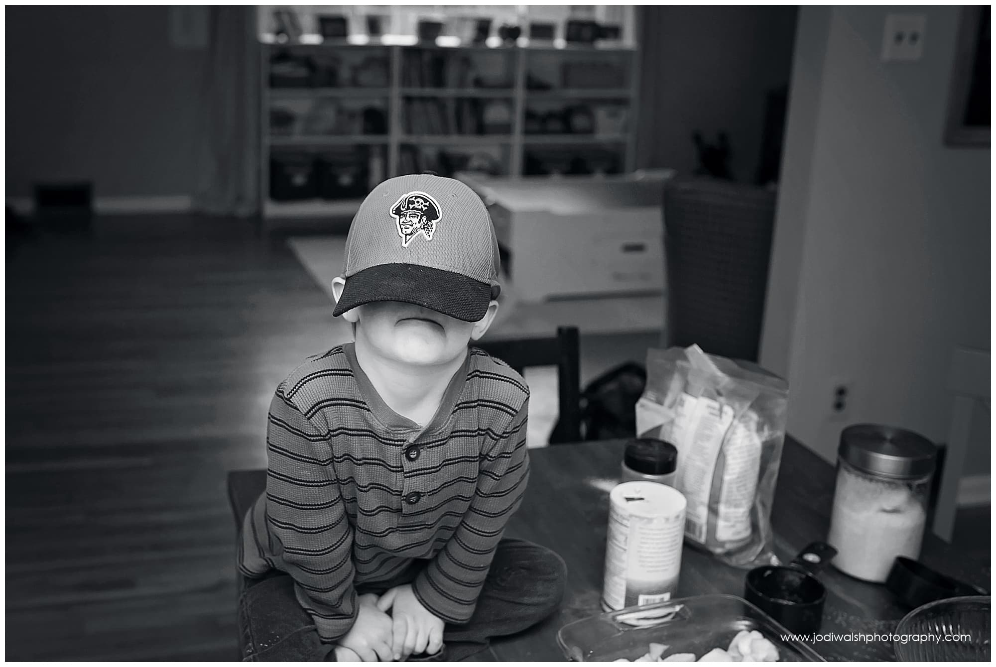 little boy with hat over his eyes