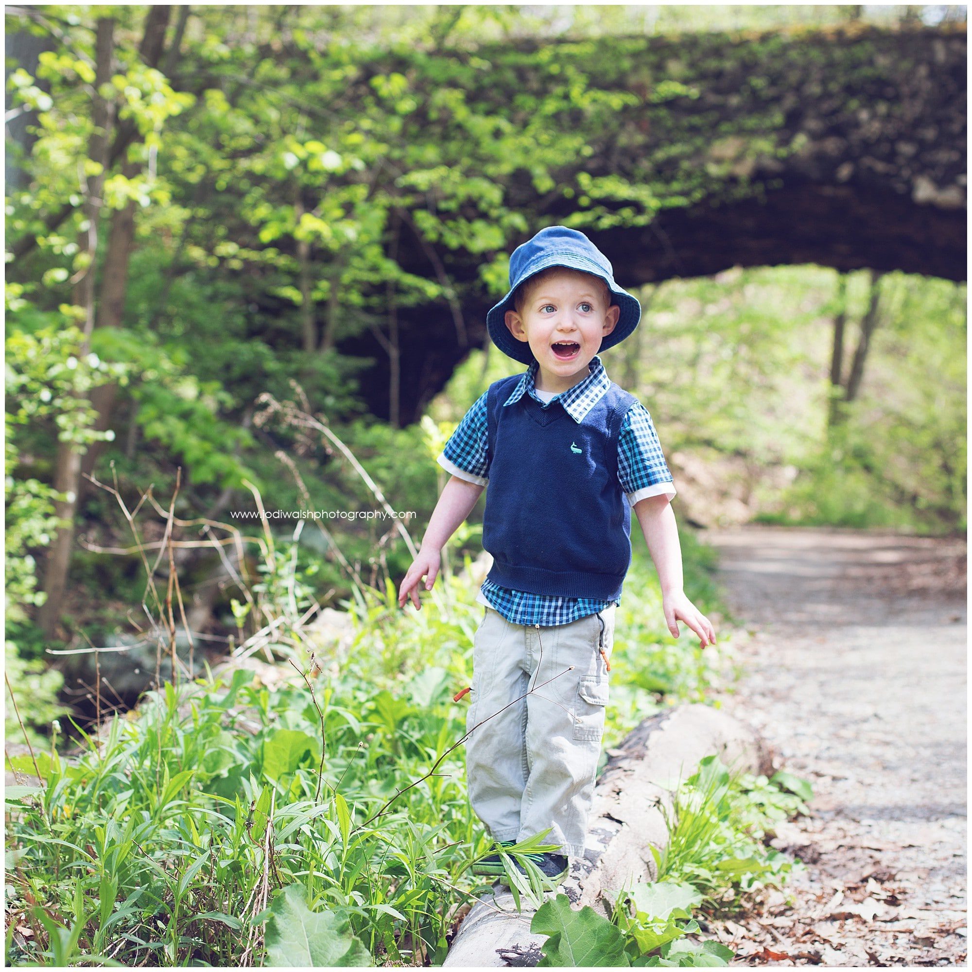 Little boy in blue hat and vest, in Schenley Park, Pittsburgh