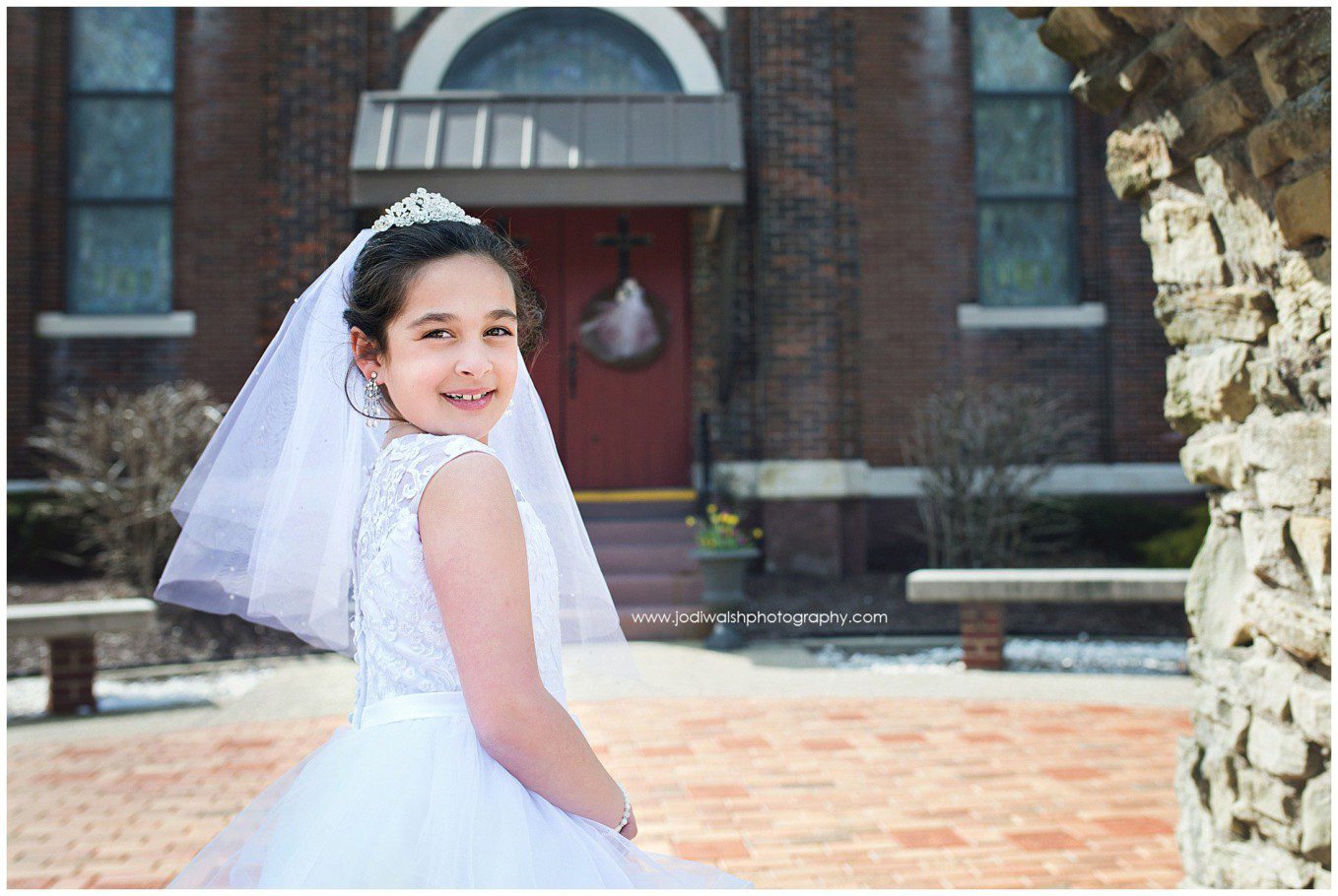 image of a little girl wearing white dress and veil for first holy communion at St Alphonsus Church, Wexford