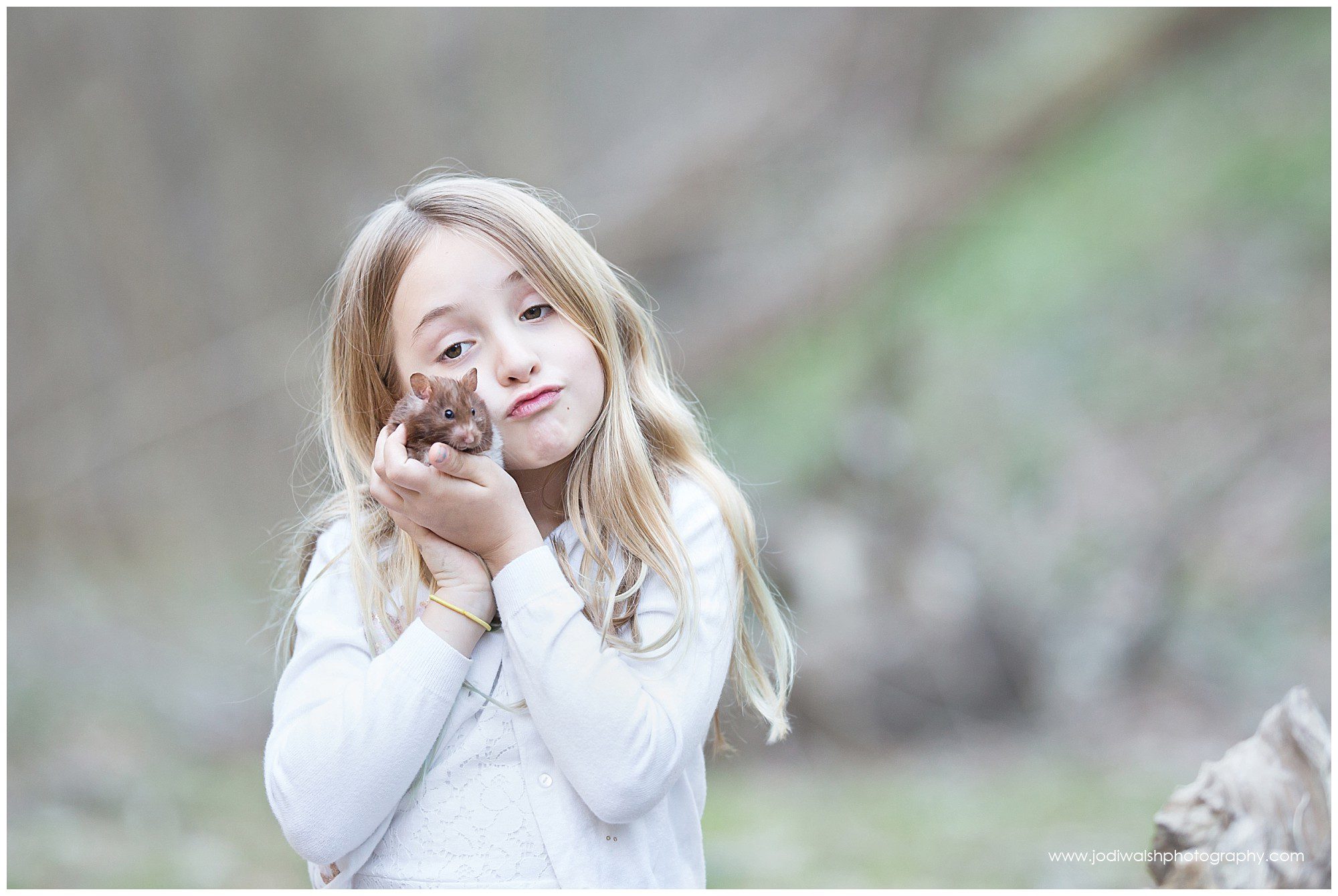 little girl holding pet hamster