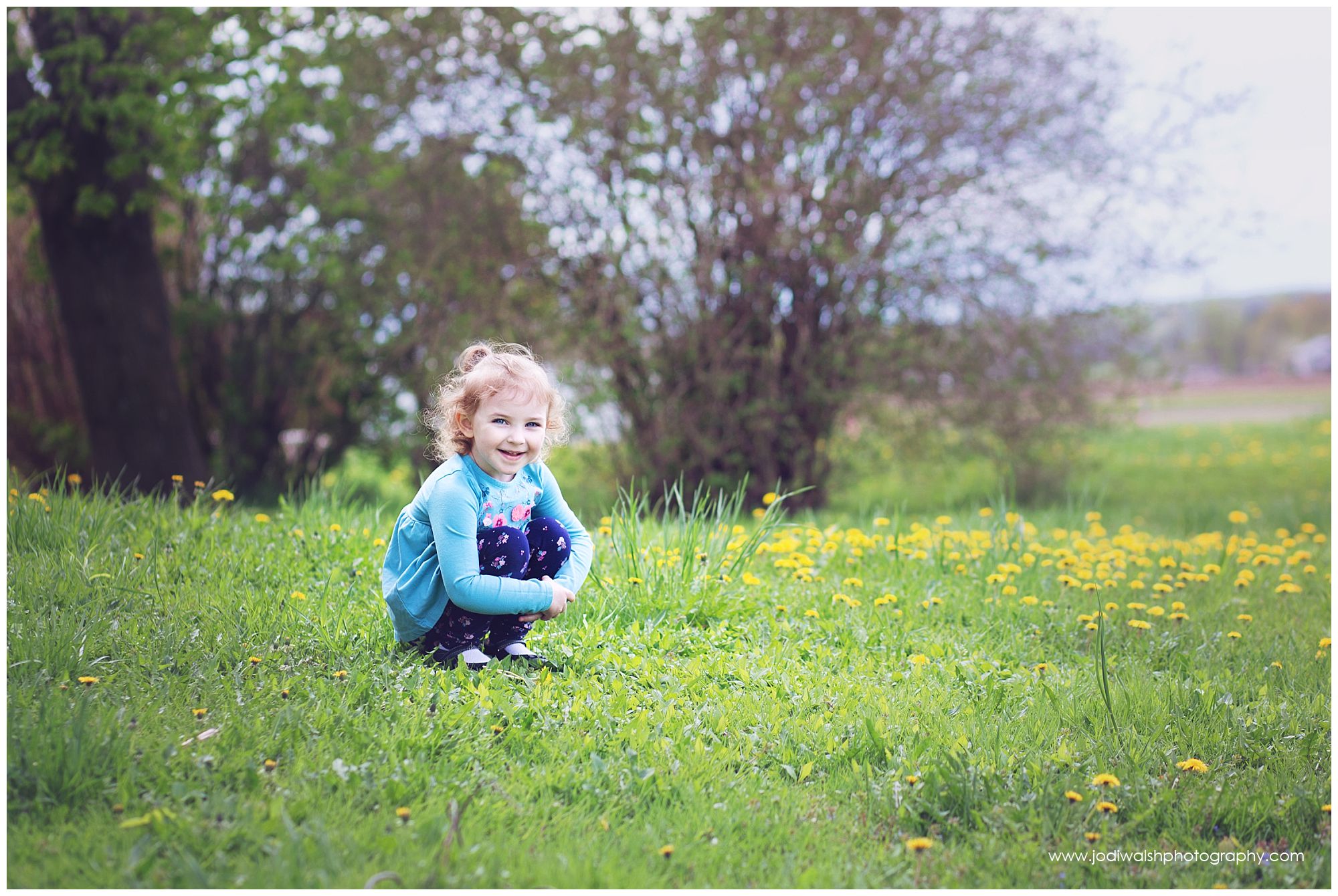 little girls in dandelion field