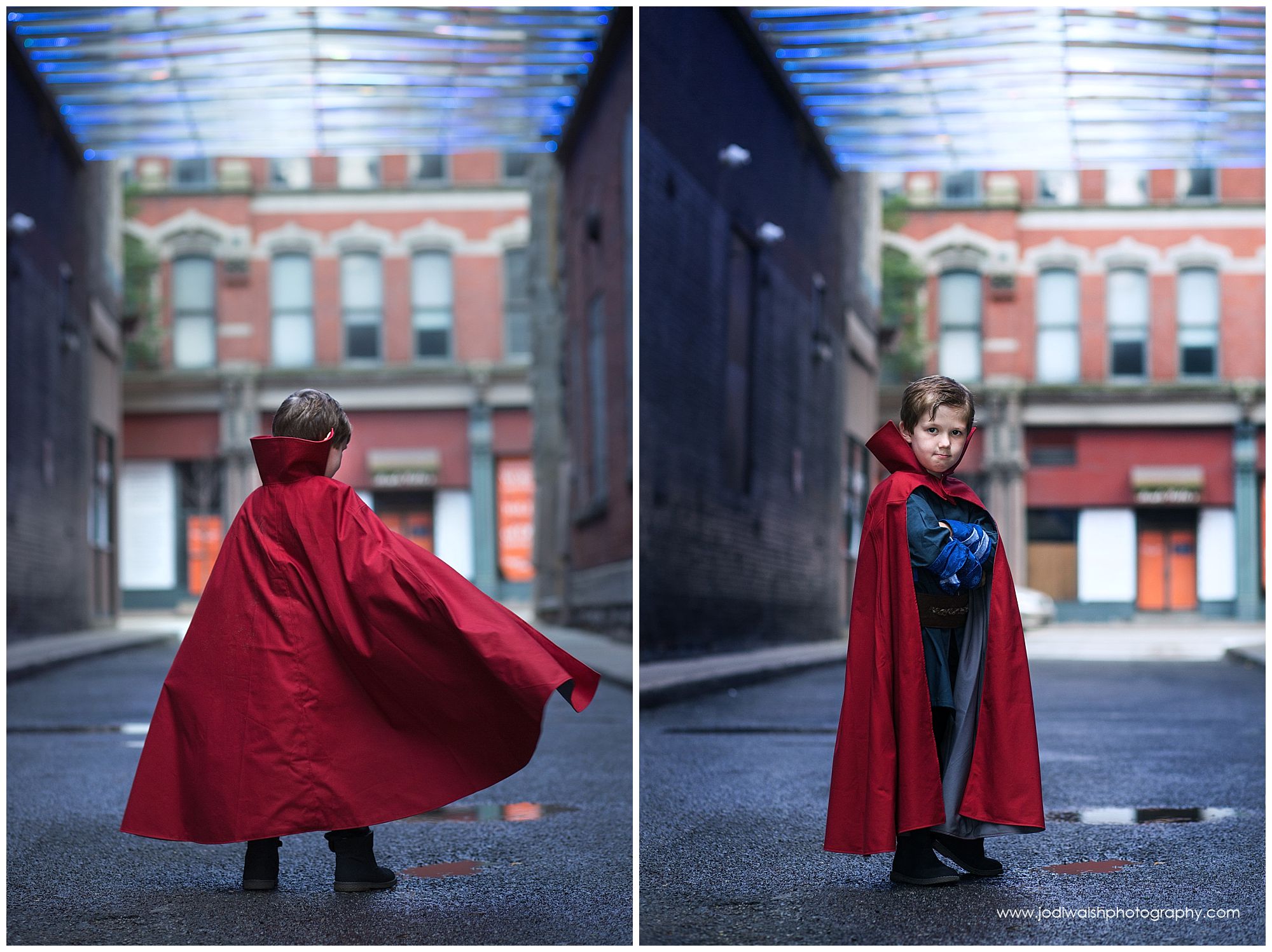 little boy wearing red cape and blue tunic in Pittsburgh alley