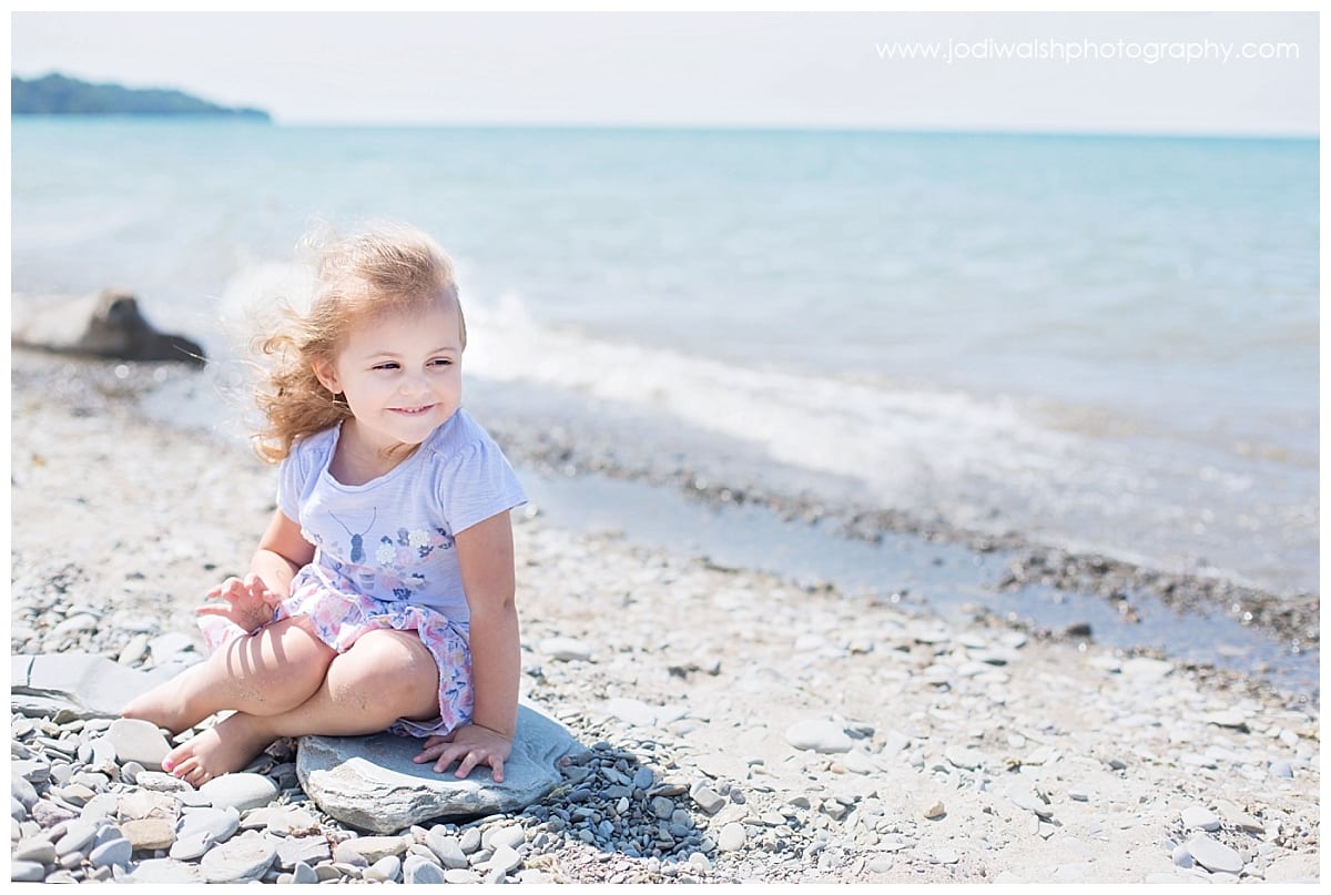 little girl sitting on the Lake Erie shore locations