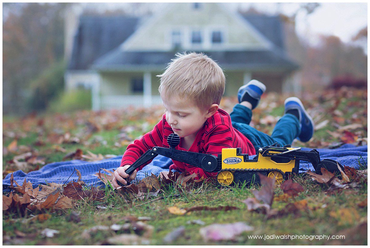 little boy playing in the dirt with toy backhoe in Wexford backyard locations