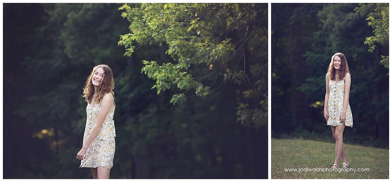 images of a senior girl in a wooded clearing in North Park.  She has dark curly hair and is wearing a white dress with flowers.