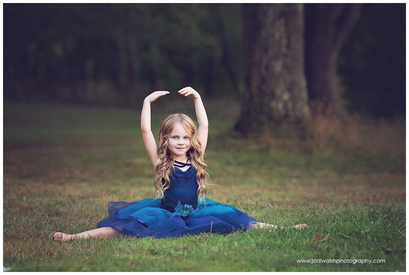 image of a little girl wearing a blue tutu and doing a split while sitting in the grass in South Park.