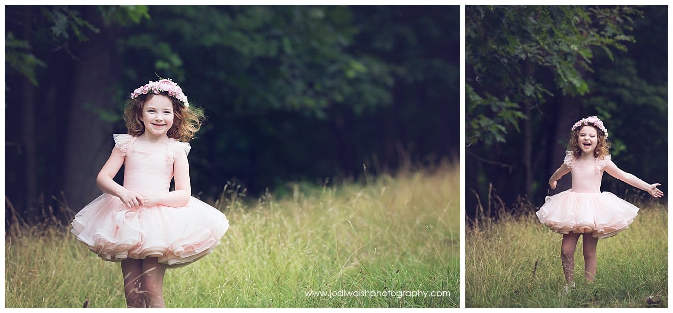 image of a little girl wearing a pink tutu princess dress.  She's standing in the tall grass at the edge of a wood in North Park.