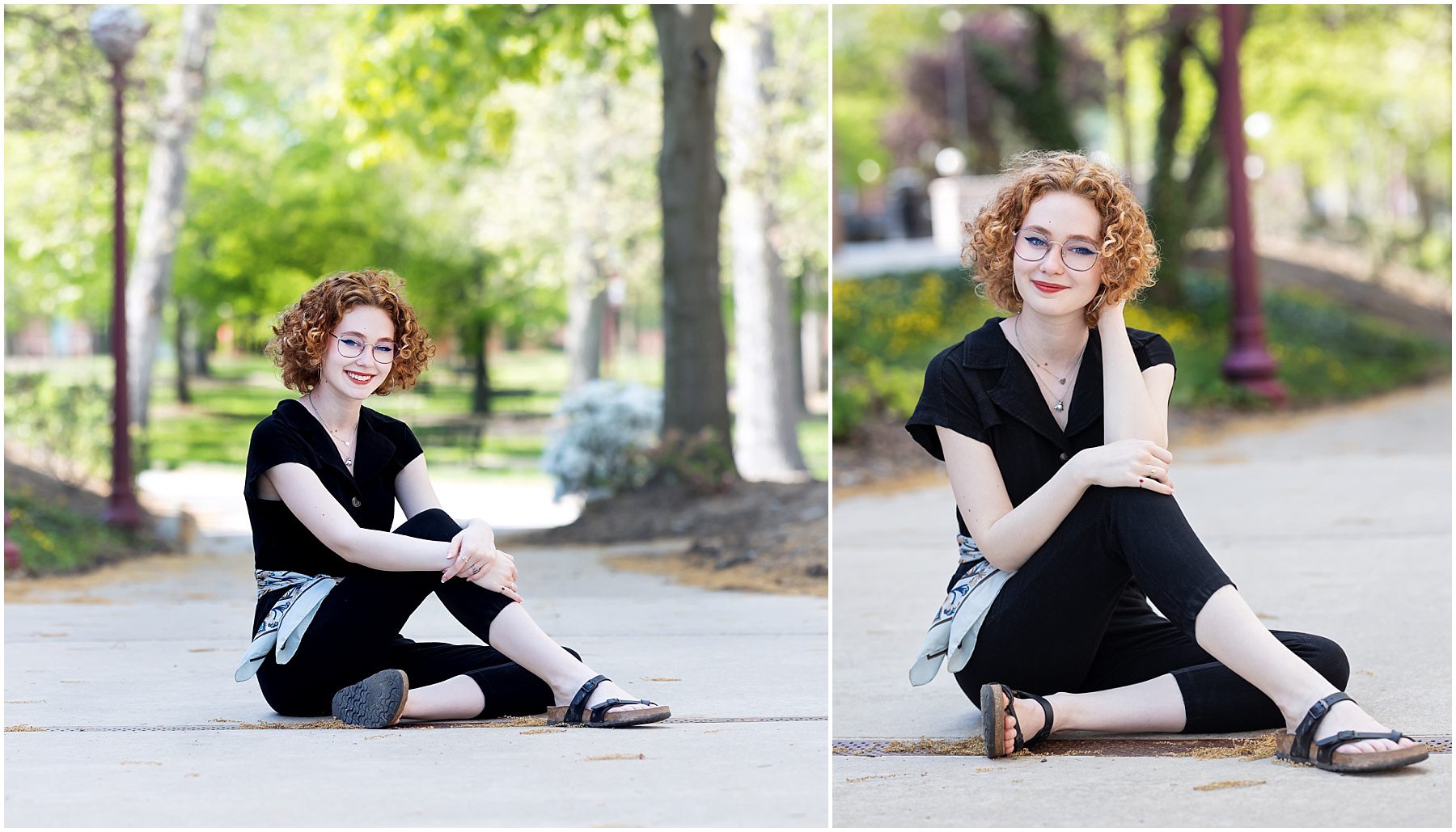 A senior girl with red, curly hair, seated on a sidewalk on IUP campus. It's summer and she's wearing a black jumpsuit with black sandals.