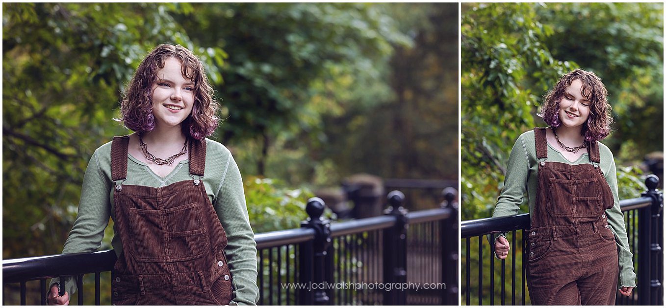 images of a senior girl in brown overalls, standing next to a black metal railing in Schenley Park, Pittsburgh