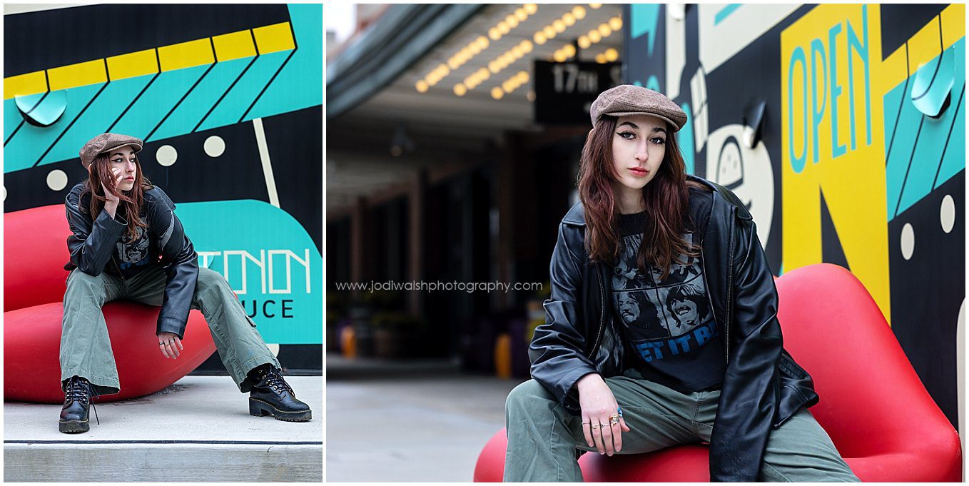 images of a senior girl sitting on a bench in the shape of red lips at the Terminal Building in the Strip District. She's wearing green cargo pants, a black leather jacket and a brown newsboy hat.