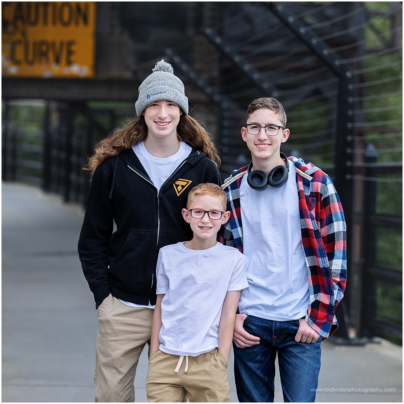 image of three brothers.  Two brothers are high school senior twins.  The younger brother is about 10.  They're standing together on the High Level Bridge in Edmonton.