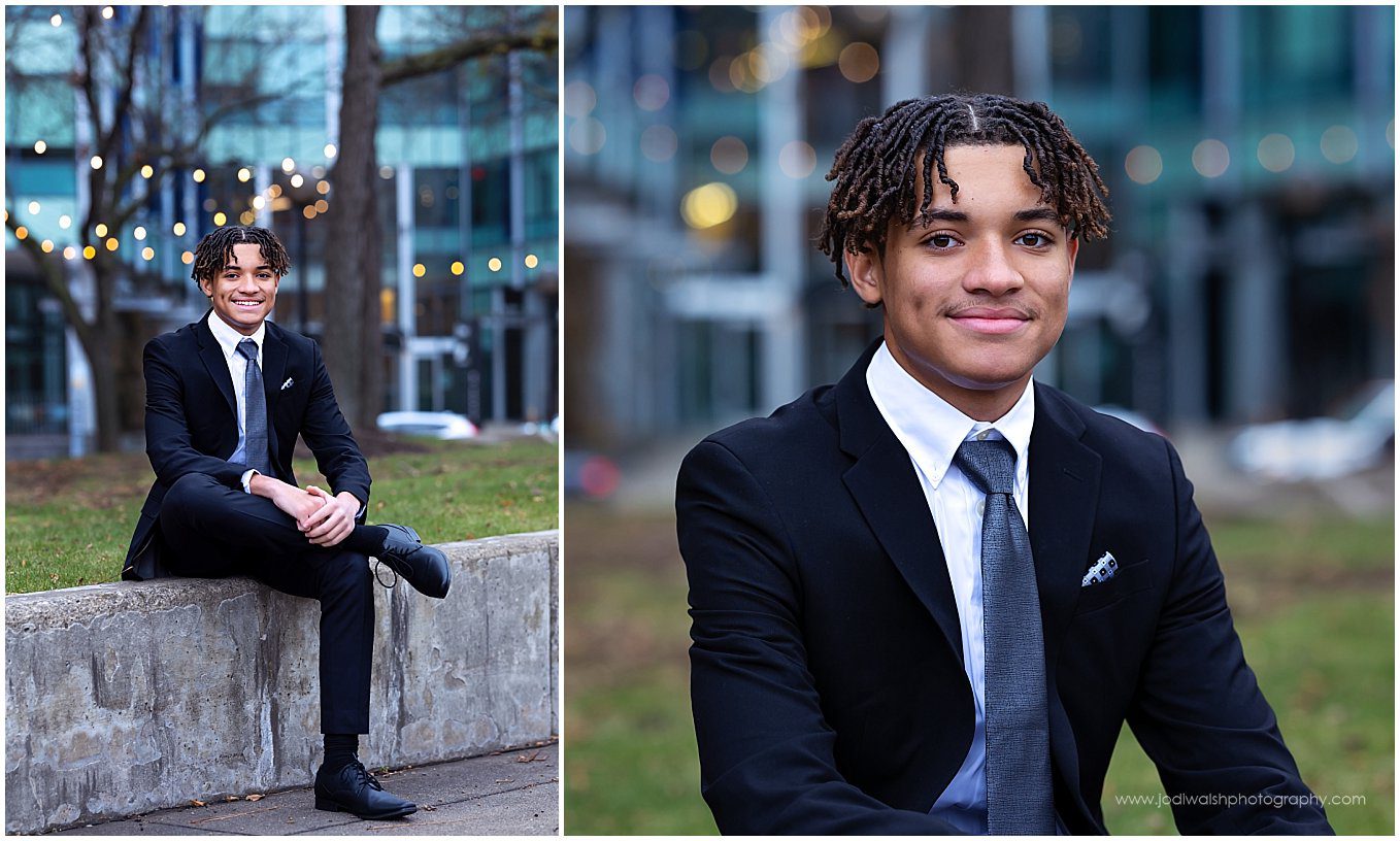images of a senior guy wearing a dark suit with a blue tie. He's seated on a low wall at Allegheny Landing on Pittsburgh's Northside neighborhood.