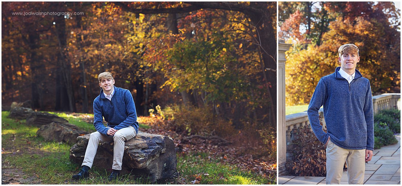 images of a senior guy on the grounds of Hartwood Acres near Pittsburgh. It's fall and there are orange and gold leaves on the trees in the background. He's wearing khaki pants and a blue sweater.